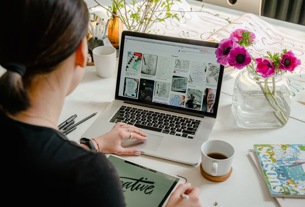 A designer working on hand-lettering and typography for a brand