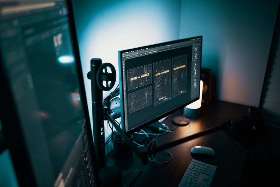 A designer reviewing brand design layouts on a studio monitor