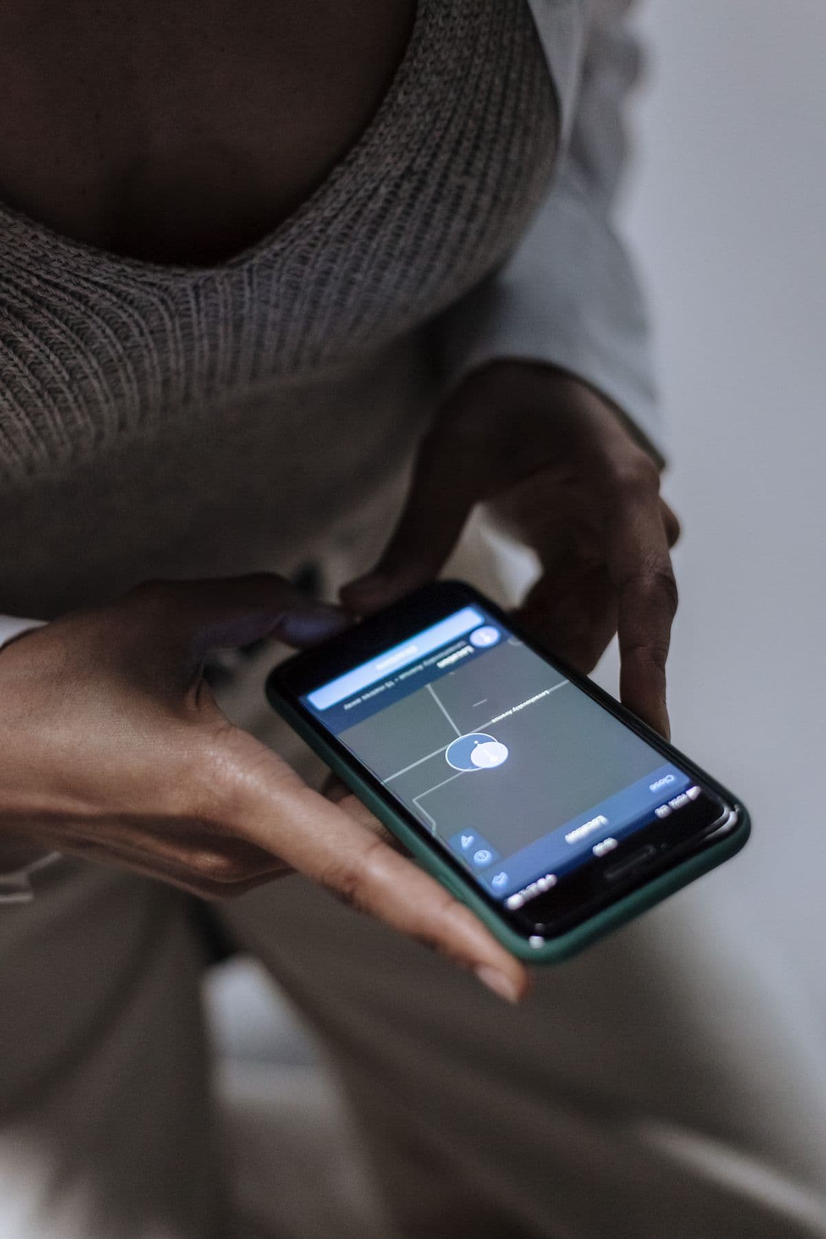 A person searching for a nearby business on a maps app on their phone